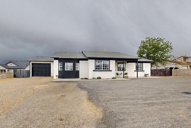 404 Pecos Loop SE, Rio Rancho, NM 87124 - view of front of property with an attached garage, stucco siding, and driveway