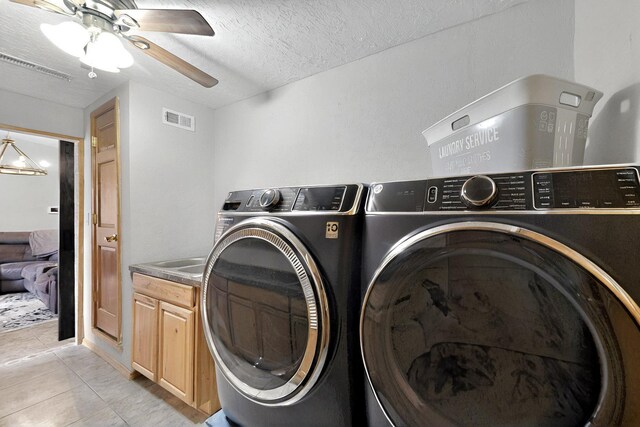 404 Pecos Loop SE, Rio Rancho, NM 87124 - laundry area featuring washing machine and clothes dryer, cabinet space, ceiling fan, light tile patterned floors, and a textured ceiling