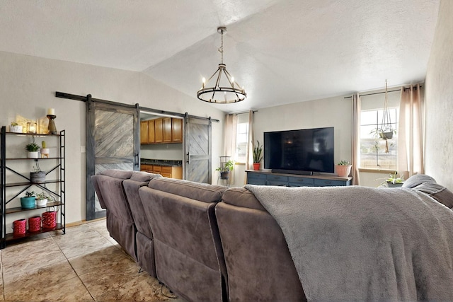 404 Pecos Loop SE, Rio Rancho, NM 87124 - living room with a barn door, a chandelier, healthy amount of natural light, vaulted ceiling, and baseboards