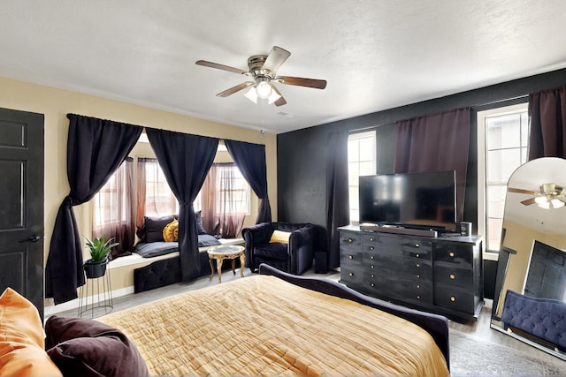 404 Pecos Loop SE, Rio Rancho, NM 87124 - bedroom with multiple windows, wood finished floors, and ceiling fan