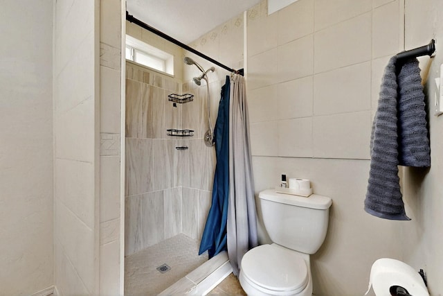 404 Pecos Loop SE, Rio Rancho, NM 87124 - bathroom featuring toilet, a shower stall, and tile walls