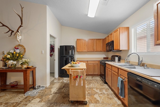 3772 Havasu Falls St NE, Rio Rancho, NM 87144 - kitchen with black appliances, a sink, vaulted ceiling, light countertops, and a kitchen island