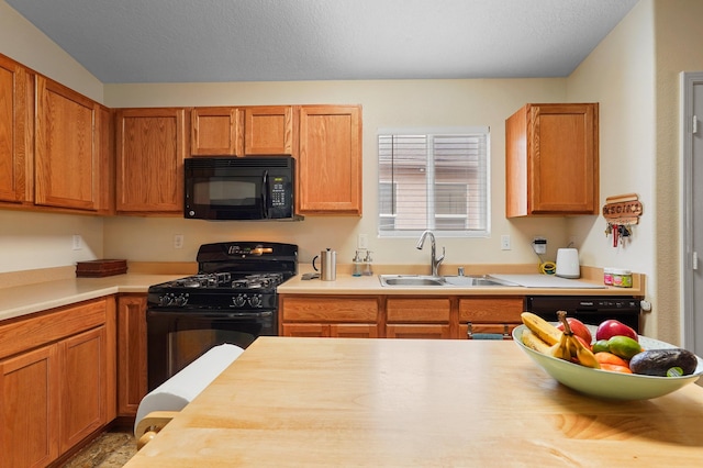 3772 Havasu Falls St NE, Rio Rancho, NM 87144 - kitchen with black appliances, a sink, and brown cabinetry