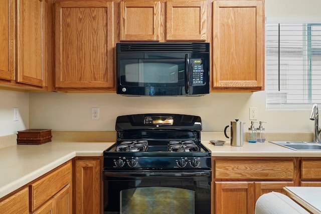 3772 Havasu Falls St NE, Rio Rancho, NM 87144 - kitchen with black appliances, a sink, and light countertops