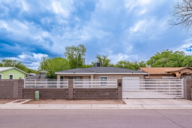 15161/2 Gallegos Rd SW, Albuquerque, NM 87105 - view of front facade featuring a fenced front yard, driveway, and an attached garage