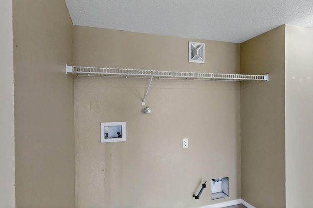 8912 Silverado Ave SW, Albuquerque, NM 87121 - washroom with gas dryer hookup, washer hookup, a textured ceiling, and baseboards