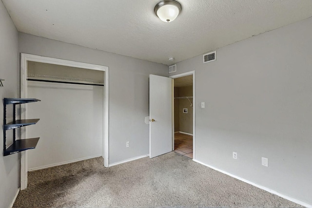 8912 Silverado Ave SW, Albuquerque, NM 87121 - unfurnished bedroom featuring carpet, a closet, baseboards, and a textured ceiling