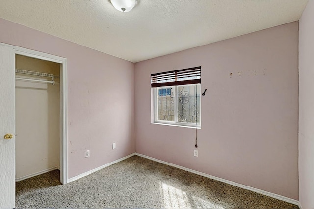 8912 Silverado Ave SW, Albuquerque, NM 87121 - unfurnished bedroom featuring carpet, baseboards, a textured ceiling, and a closet