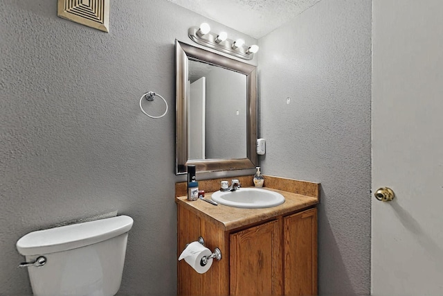 8912 Silverado Ave SW, Albuquerque, NM 87121 - half bathroom featuring vanity, toilet, and a textured wall