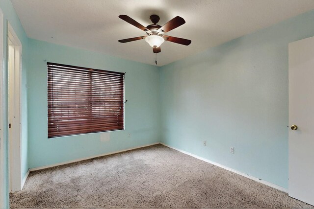 8912 Silverado Ave SW, Albuquerque, NM 87121 - spare room featuring carpet floors, a ceiling fan, and baseboards