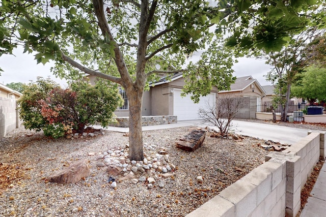 8912 Silverado Ave SW, Albuquerque, NM 87121 - obstructed view of property with fence, driveway, a garage, and stucco siding