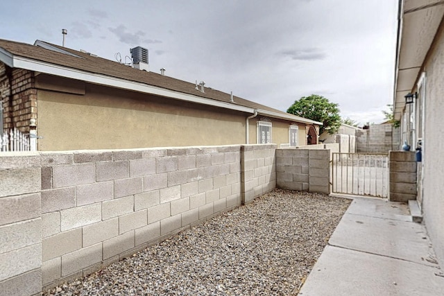 8912 Silverado Ave SW, Albuquerque, NM 87121 - view of side of property featuring a gate, fence, and stucco siding