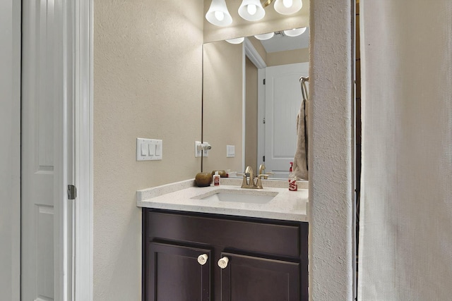 7241 Aldan Dr NE, Rio Rancho, NM 87144 - bathroom featuring a textured wall and vanity