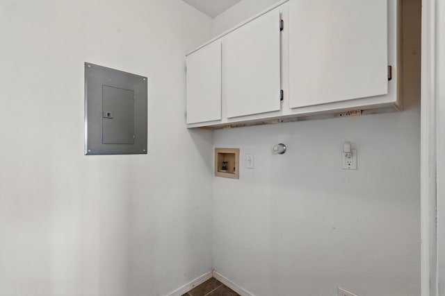 laundry room with cabinet space, electric panel, washer hookup, and baseboards
