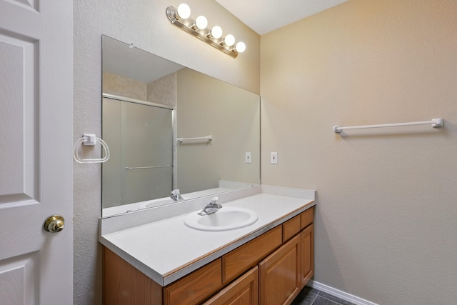 full bath featuring vanity and a shower with shower door