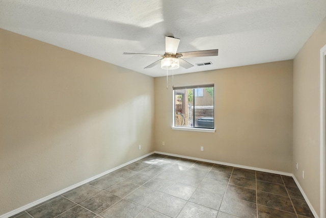 unfurnished room with ceiling fan, baseboards, and tile patterned floors