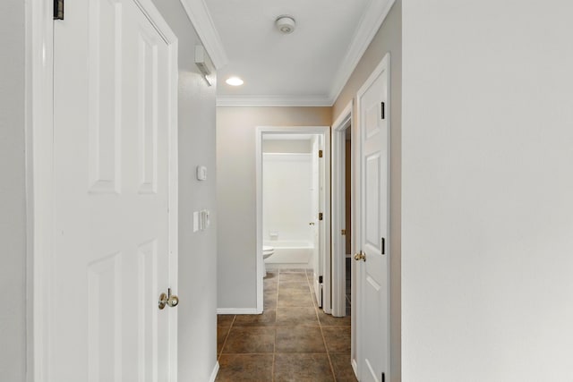 hall featuring crown molding, baseboards, and recessed lighting