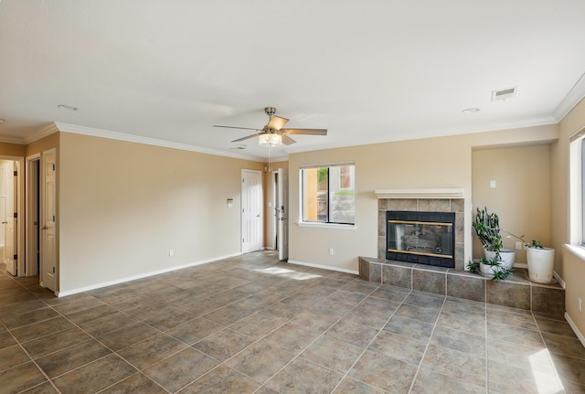 unfurnished living room with ceiling fan, a tile fireplace, crown molding, baseboards, and tile patterned flooring