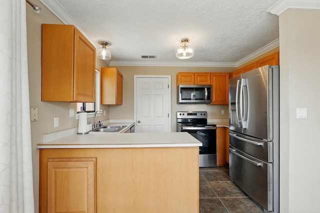 kitchen with appliances with stainless steel finishes, a sink, a peninsula, light countertops, and crown molding