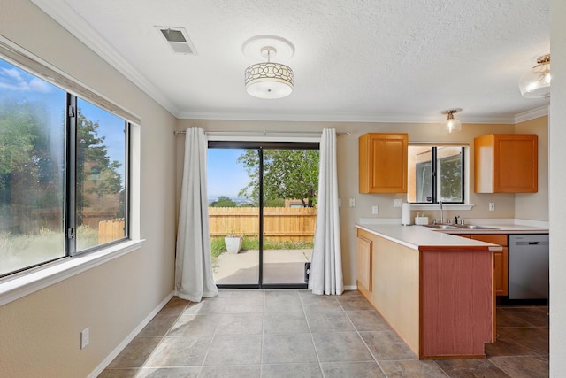kitchen with stainless steel dishwasher, a sink, plenty of natural light, light countertops, and ornamental molding