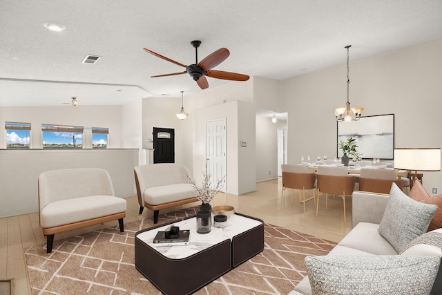 4700 Crestridge Ave NW, Albuquerque, NM 87114 - living room with vaulted ceiling, a ceiling fan, and a chandelier