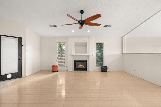 4700 Crestridge Ave NW, Albuquerque, NM 87114 - unfurnished living room with a ceiling fan, a tiled fireplace, and recessed lighting