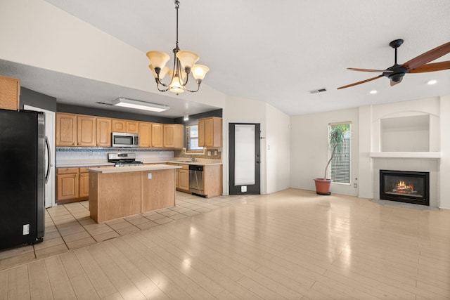 4700 Crestridge Ave NW, Albuquerque, NM 87114 - kitchen with stainless steel appliances, open floor plan, light countertops, a center island, and a chandelier