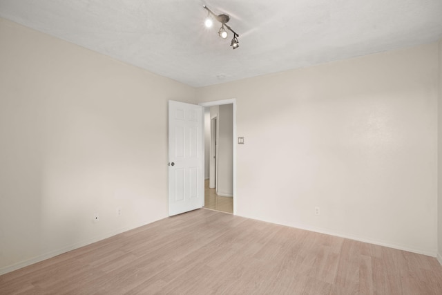 4700 Crestridge Ave NW, Albuquerque, NM 87114 - unfurnished room with light wood-type flooring, baseboards, and track lighting