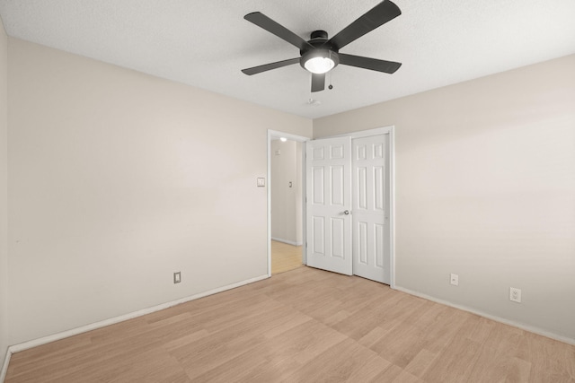 4700 Crestridge Ave NW, Albuquerque, NM 87114 - unfurnished bedroom with wood finished floors, baseboards, a closet, and ceiling fan