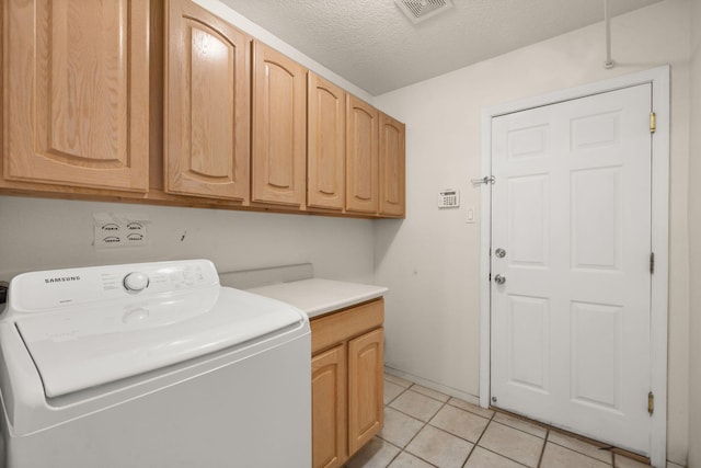 4700 Crestridge Ave NW, Albuquerque, NM 87114 - laundry area with washer / dryer, cabinet space, light tile patterned floors, and a textured ceiling