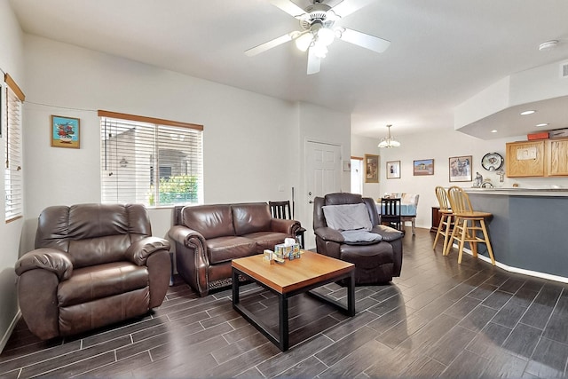 living room with wood finish floors, ceiling fan, baseboards, a chandelier, and recessed lighting