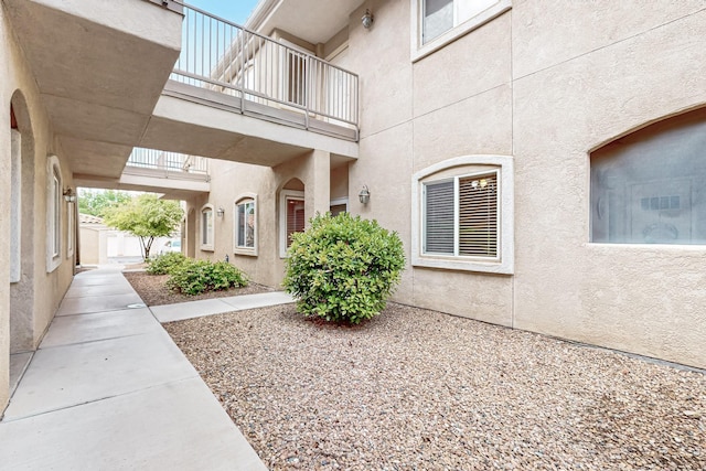 entrance to property with stucco siding