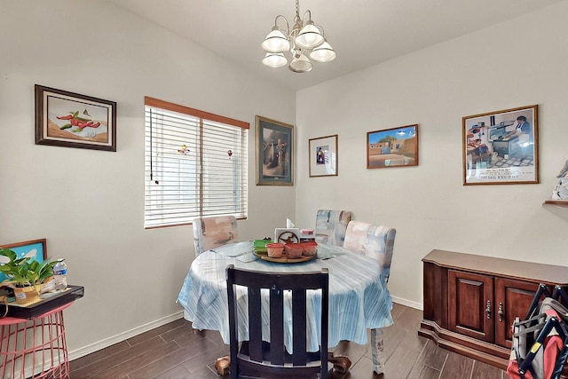 dining room featuring a chandelier, baseboards, and dark wood-style floors