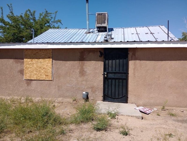 376 58th St NW, Albuquerque, NM 87105 - entrance to property featuring stucco siding, central AC, and metal roof
