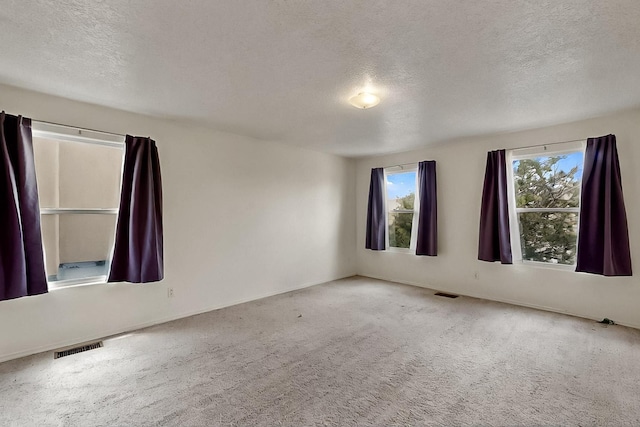 2512 Sarita Ave NW, Albuquerque, NM 87104 - unfurnished room featuring a textured ceiling, carpet flooring, and baseboards