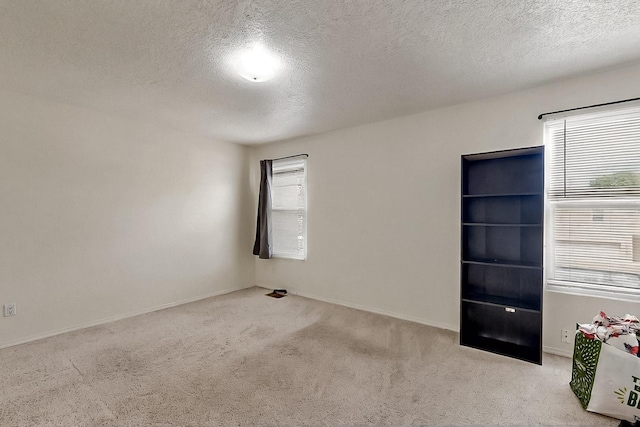 2512 Sarita Ave NW, Albuquerque, NM 87104 - carpeted spare room with a textured ceiling and baseboards