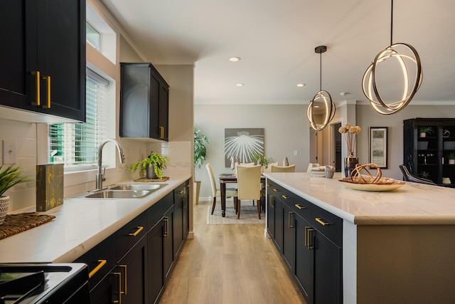 1899 Vargas Rd SE, Rio Rancho, NM 87124 - kitchen with a sink, light wood finished floors, hanging light fixtures, a center island, and recessed lighting