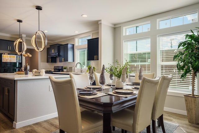 1899 Vargas Rd SE, Rio Rancho, NM 87124 - dining space with light wood finished floors, baseboards, recessed lighting, and ornamental molding
