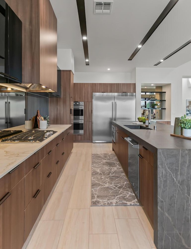 6511 Vista Del Prado, Albuquerque, NM 87120 - kitchen with modern cabinets, stainless steel appliances, wall chimney range hood, a sink, and light tile patterned floors