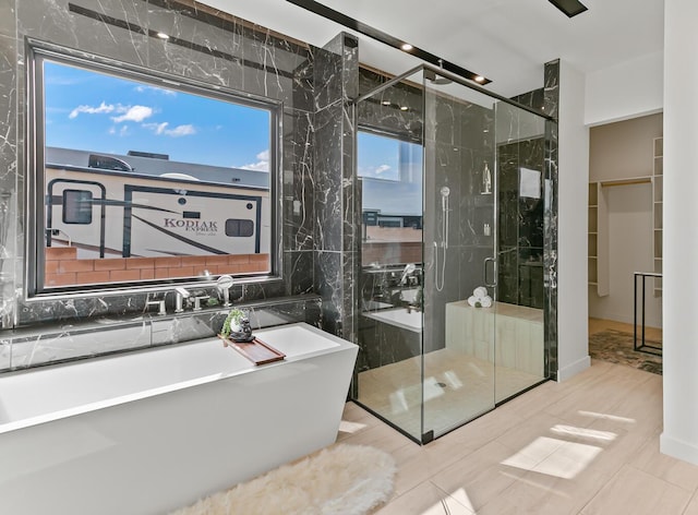 6511 Vista Del Prado, Albuquerque, NM 87120 - bathroom featuring a stall shower, plenty of natural light, a freestanding bath, and a walk in closet