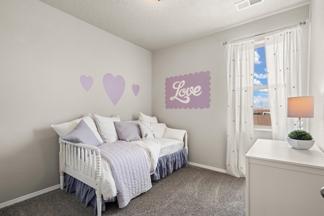 carpeted bedroom featuring baseboards and a textured ceiling