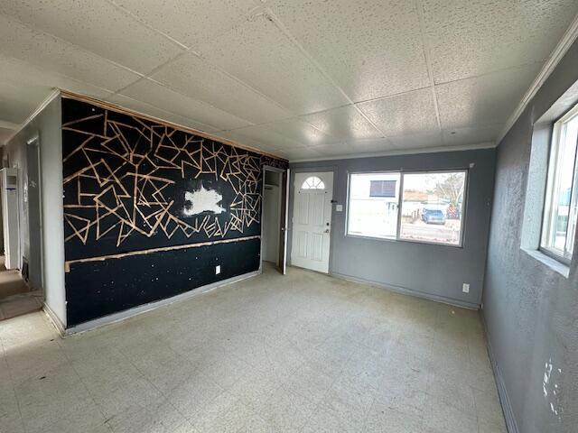 1205 Del Norte Blvd, Grants, NM 87020 - empty room featuring tile patterned floors, plenty of natural light, baseboards, and crown molding