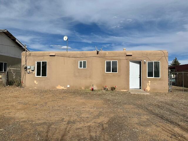1205 Del Norte Blvd, Grants, NM 87020 - back of property with fence and stucco siding