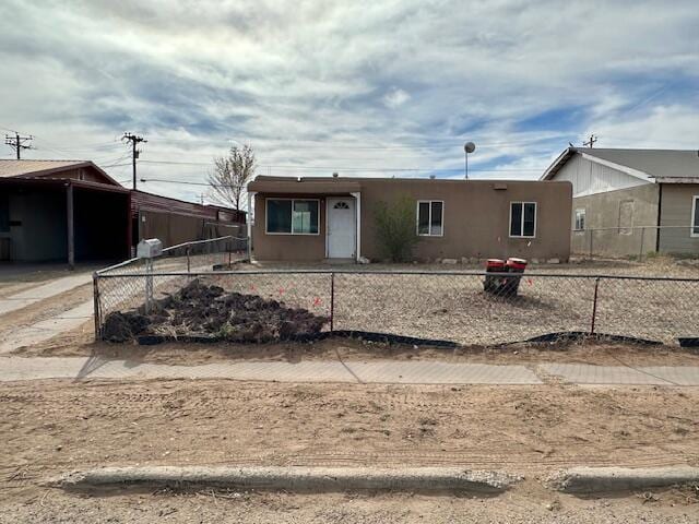 1205 Del Norte Blvd, Grants, NM 87020 - ranch-style house with stucco siding and a fenced front yard
