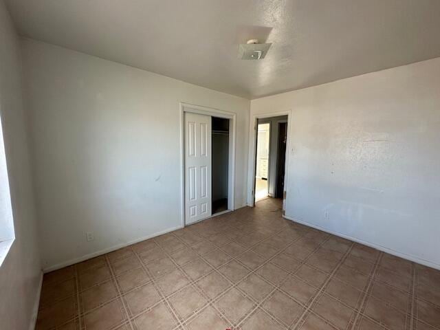 1205 Del Norte Blvd, Grants, NM 87020 - unfurnished bedroom with a closet and baseboards