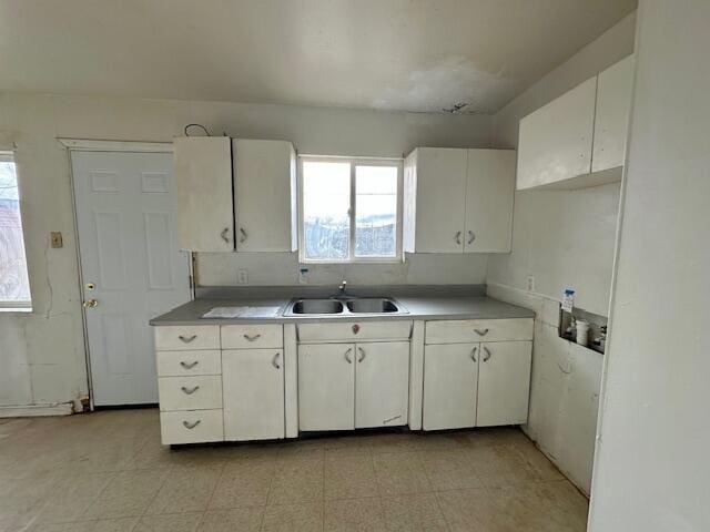 1205 Del Norte Blvd, Grants, NM 87020 - kitchen featuring a sink, plenty of natural light, white cabinets, and light countertops