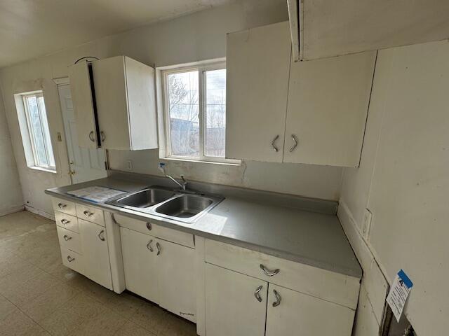 1205 Del Norte Blvd, Grants, NM 87020 - kitchen featuring a sink, white cabinets, light floors, and light countertops