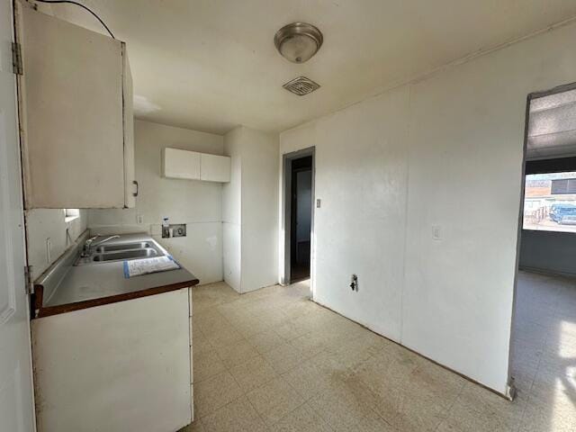 1205 Del Norte Blvd, Grants, NM 87020 - kitchen featuring light flooring, white cabinetry, and a sink