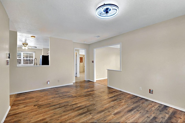 5721 Miller Rd NE, Rio Rancho, NM 87144 - spare room featuring wood finished floors, baseboards, a textured ceiling, and ceiling fan