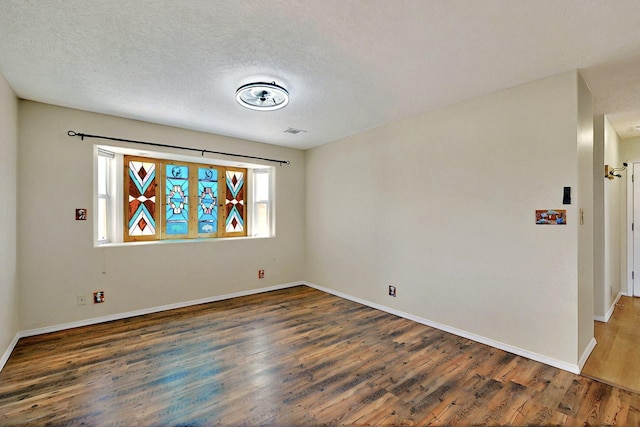 5721 Miller Rd NE, Rio Rancho, NM 87144 - unfurnished room featuring wood finished floors, baseboards, and a textured ceiling